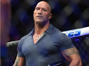 Dwayne Johnson aka The Rock prepares to present the BMF belt after the fight between Jorge Masvidal (red gloves) and Nate Diaz (blue gloves) during UFC 244 at Madison Square Garden.