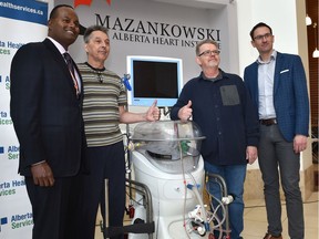 Doctors Jayan Nagendran, left, and Darren Freed, right, inventors of the Organ Support System (EVOSS) pose with lung transplant recipients Ron Kruse, second from right, and Ron Schaworski as the University Hospital Foundation celebrates 12 successful lung transplants using the Ex-Vivo (EVOSS) device, at the Mazankowski Alberta Heart Institute in Edmonton, Thursday, Nov. 7, 2019.
