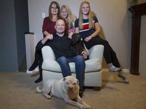 Darren Reynes with his wife Michelle and daughters Kaeden, 11, and Nevaeh, in their Edmonton home.
