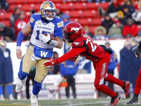 Calgary Stampeders, Jamar Wall tries to tackle Winnipeg Blue Bombers QB, Chris Streveler during the CFL semi-finals in Calgary on Sunday, November 10, 2019. Darren Makowichuk/Postmedia