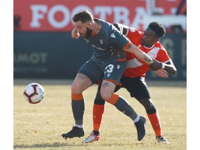 Forge FC Anthony Novak (L) is marked by Cavalry FC Nathan Mavila during leg 2 Canadian Premier League Championship soccer action between Forge FC and Cavalry FC at ATCO Field at Spruce Meadows in Calgary on Saturday, November 2, 2019. Jim Wells/Postmedia