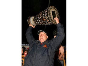 Ian MacAlpine imacalpine@thewhig.com  Queen's Golden Gaels coach Pat Sheahan hoists the Yates Cup after Queen's beat Western 43-39 to win the OUA championship on November 14 2009.