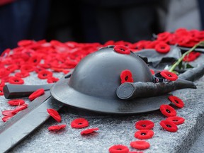 In Nov. 11, 2014, file photo, poppies sit on the Tomb of the Unknown Soldier after a Remembrance Day ceremony, in Ottawa.