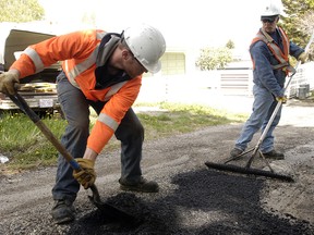 City of Calgary workers fill potholes on Thorncliffe Crescent N.W.