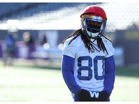 Returner Janarion Grant stays warm during Blue Bombers practice on Thursday in Winnipeg. Photo by Kevin King/Postmedia.
