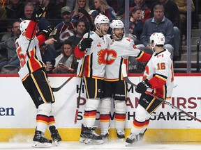 Michael Frolik and his teammates celebrate a goal against the Colorado Avalanche in the third period on Dec. 9, 2019 in Denver.