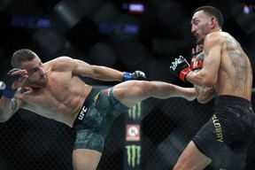 Alexander Volkanovski (L) kicks UFC featherweight champion Max Holloway in their title fight during UFC 245 at T-Mobile Arena on Dec. 14, 2019, in Las Vegas.