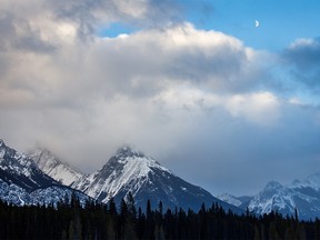 The half-moon and chinook clouds near the east end of Smith-Dorrien Trail south of Canmore, Ab., on Tuesday, December 3, 2019. Mike Drew/Postmedia