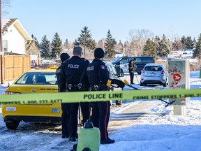 Police are investigating the scene of a shooting in Rundlemere Road N.E. using metal detectors to look for bullet cases on Monday, December 30, 2019. Azin Ghaffari/Postmedia