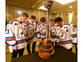 Calgary MIdget AAA Buffaloes players look a the trophy at a press conference to kick off the Macs International Hockey Tournament in Calgary on Wednesday, December 11, 2019.