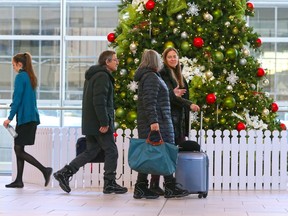 Travellers move through the Calgary International Airport on Monday December 16, 2019.