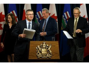 Finance Minister Travis Toews, second from left, at a news conference at the Alberta legislature on Wednesday, Dec. 18, 2019.