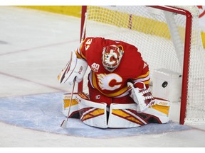 The puck hits the back of the net behnd goalie David Rittich for Canucks second goal during NHL action between the Calgary Flames and the Vancouver Canucks in Calgary on Sunday, December 29, 2019. Jim Wells/Postmedia