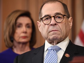 House Speaker Nancy Pelosi (D-CA) listens next to House Judiciary Chairman Jerry Nadler, right, Democrat of New York, House Permanent Select Committee on Intelligence House Committee on Oversight, speak to announce articles of impeachment for U.S. President Donald Trump during a press conference at the U.S. Capitol in Washington, D.C., Dec. 10, 2019. (SAUL LOEB/AFP via Getty Images)