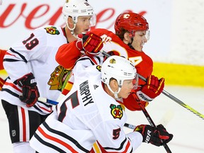 Calgary Flames Matthew Tkachuk battles against Connor Murphy and Jonathan Toews of the Chicago Blackhawks during NHL hockey in Calgary on Tuesday December 31, 2019. Al Charest / Postmedia