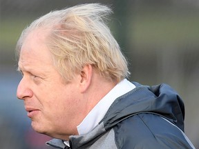 Britain's Prime Minister Boris Johnson takes part in a warm up with a junior girls football team while on the campaign trail in Cheadle Hulme, northwest England on Dec. 7, 2019.