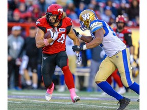 Calgary Stampeders Ante Milanovic-Litre is tackled by Jackson Jeffcoat Winnipeg Blue Bombers during CFL football in Calgary on Saturday, October 19, 2019. Al Charest/Postmedia