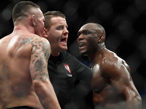 Kamaru Usman (right) and Colby Covington are separated by referee Marc Goddard during UFC 245 at T-Mobile Arena. (Stephen R. Sylvanie-USA TODAY Sports)