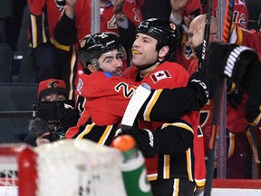 Dillon Dube, left, and Milan Lucic celebrate at goal against the Buffalo Sabres in Calgary on Dec. 5, 2019.