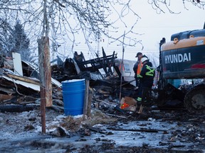 Emergency responders sift through the rubble of a house fire that claimed five lives, including three children, in Mayerthorpe.