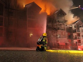Emergency crews respond to a condo fire along 14th Street and 23rd Avenue S.W. as flames shoot out from the roof. More than 100 residents were displaced by the fire on Friday, Dec. 20, 2019.