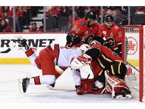 Dec 14, 2019; Calgary, Alberta, CAN; Carolina Hurricanes right wing Warren Foegele (13) collides with Calgary Flames goalie David Rittich (33) during the second period at Scotiabank Saddledome. Mandatory Credit: Candice Ward-USA TODAY Sports ORG XMIT: USATSI-405497