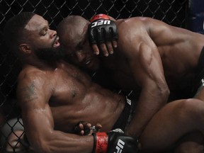 Tyron Woodley (left) and Kamaru Usman (right) grapple during their welterweight title bout during UFC 235 at T-Mobile Arena in Las Vegas on March 2, 2019.