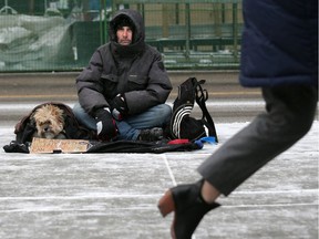 Vern and his dog Bam Bam huddle to stay warm in the -13 C cold while asking for spare change in downtown Calgary Wednesday, November 27, 2019. Gavin Young/Postmedia