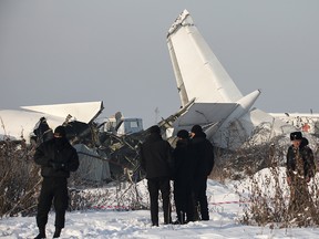 Emergency and security personnel are seen at the site of a plane crash near Almaty, Kazakhstan, Dec. 27, 2019.