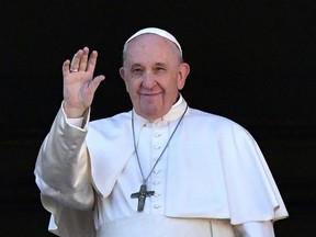 Pope Francis waves from the balcony of St. Peter's basilica during the traditional "Urbi et Orbi" Christmas message to the city and the world, at St Peter's square in the Vatican, Wednesday, Dec. 25, 2019.