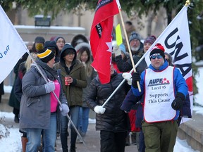 Union members protest government cuts at a rally in downtown Calgary on Friday, Nov. 29, 2019.
