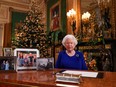 A picture released on Dec. 24, 2019 shows Britain's Queen Elizabeth II posing for a photograph after she recorded her annual Christmas Day message, in Windsor Castle, west of London.