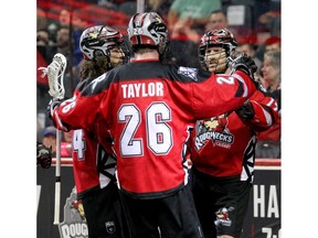 The Roughnecks celebrate after Curtis Dickson scores a goal during first-half NLL action against the Philadelphia Wings at the Saddledome on Saturday night. Photo by Brendan Miller/Postmedia.