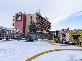 Calgary firefighters attend a fire at the Town & Country Hotel in southeast Calgary on Monday, Dec. 23, 2019.