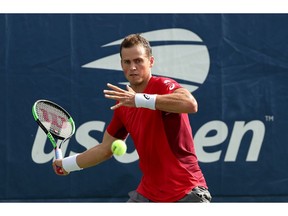 NEW YORK, NEW YORK - AUGUST 27: Vasek Pospisil of Canada returns a shot against Karen Khachanov of Russia during their Men's Singles first round match on day two of the 2019 US Open at the USTA Billie Jean King National Tennis Center on August 27, 2019 in the Flushing neighborhood of the Queens borough of New York City.