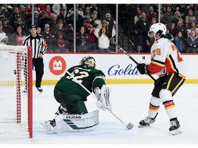 ST PAUL, MINNESOTA - JANUARY 05: Dillon Dube #29 of the Calgary Flames scores a goal against goalie Alex Stalock #32 of the Minnesota Wild during the shootout of the game at Xcel Energy Center on January 5, 2020 in St Paul, Minnesota. The Flames defeated the Wild 5-4 in a shootout.