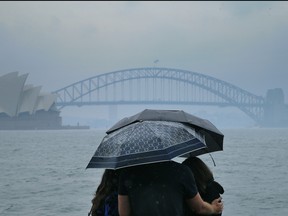 Tourists are seen looking at The Sydney Harbour Bridge in the rain on Jan. 17, 2020 in Sydney, Australia. (Jenny Evans/Getty Images)