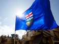 An Alberta provincial flag is surrounded by pipeline heavy machinery in Edmonton. David Bloom/Postmedia files