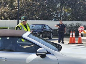 Palm Beach Police and Palm Beach County Sheriff's deputies set up a checkpoint at the intersection of S. County Rd. and S. Ocean Blvd. Friday in Palm Beach, Fla., on Friday, Jan. 31, 2020. (Damon Higgins/The Palm Beach Post via AP)