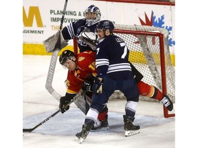 Men's UCalgary Dinos, Tim Vanstone battles MRU Cougars, Jesse Lees in second period action as the Calgary Flames hosted the Crowchild Classic at the Scotiabank Saddledome on. The on-ice contests will feature the women's and men's hockey teams from the University of Calgary and Mount Royal University in back-to-back action. This double header is a part of the Crowchild Classic series, an ongoing contest between the two universities on Tuesday January 29, 2019. Darren Makowichuk/Postmedia