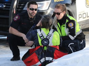 Police and EMS help a Canada Post worker who was pepper-sprayed while making deliveries in Killarney on Tuesday, Jan. 21, 2020. Police arrested two suspects nearby.