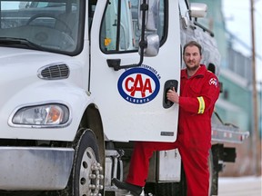 Trevor Snyder escaped injury when a semi-trailer rear-ended his tow truck on Highway 2 near Innisfail on Jan. 22, 2020. The driver of the semi died in the accident. Snyder is photographed with one of his other trucks in Beiseker.