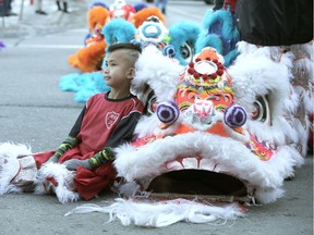 Brady Hui, 7 yrs, a performer with Jing Wo Cultural Association, rests before he Chinese New Year celebrations in downtown Calgary on Saturday, January 25, 2020.