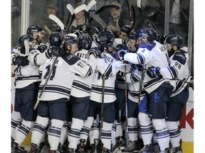 The Mount Royal Cougars celebrate during men's hockey action as the Mount Royal Cougars beat the University of Calgary Dino's 5-4 in double overtime in the 2020 Crowchild Classic at the Saddledome. Thursday, January 30, 2020. Brendan Miller/Postmedia