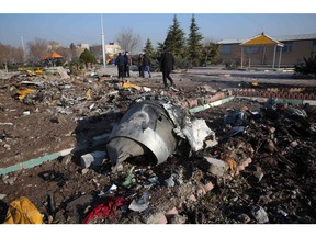 TOPSHOT - Rescue teams work amidst debris after a Ukrainian plane carrying 176 passengers crashed near Imam Khomeini airport in the Iranian capital Tehran early in the morning on January 8, 2020, killing everyone on board. - The Boeing 737 had left Tehran's international airport bound for Kiev, semi-official news agency ISNA said, adding that 10 ambulances were sent to the crash site. (Photo by - / AFP)
