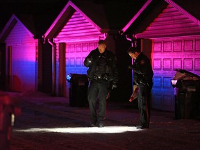 Police search an alley behind the 200 block of Saddlecrest Blvd N.E. after a fatal shooting on Saturday evening January 4, 2019.