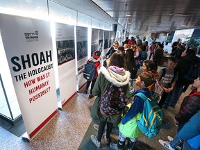 Students read about the Holocaust at the City of Calgary’s first International Holocaust Remembrance Day ceremony at City Hall on Monday, January 27, 2020. Gavin Young/Postmedia