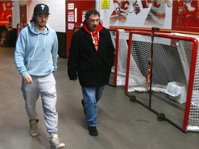 Calgary Flames forward Johnny Gaudreau walks with his father Guy after practice at the Saddledome. Flames players and their fathers are getting together for the team's annual Dad's trip that will see them travel to Minnesota and Chicago with the team.