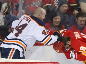 Oilers Zack Kassian and Flames Matthew Tkachuk battle in the second period during NHL action between the Edmonton Oilers and the Calgary Flames in Calgary on Saturday, January 11, 2020.