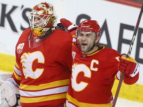 Flames goalie Cam Talbot and Mark Giordano celebrate the win over the Oilers during NHL action between the Edmonton Oilers and the Calgary Flames in Calgary on Saturday, January 11, 2020.